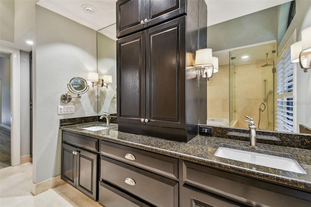3308 Landing Pl, Palm Harbor, FL 34684 - bathroom featuring double vanity, a shower stall, tile patterned flooring, and baseboards