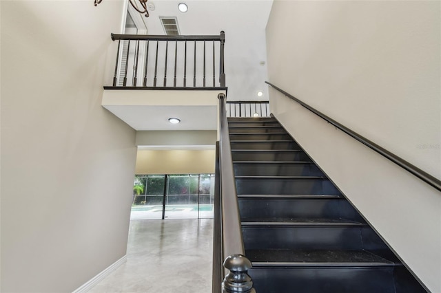 3308 Landing Pl, Palm Harbor, FL 34684 - staircase with a high ceiling and baseboards