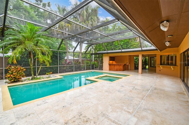 3308 Landing Pl, Palm Harbor, FL 34684 - view of pool featuring a patio area, glass enclosure, and a pool with connected hot tub