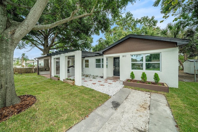 3812 W Rogers Ave, Tampa, FL 33611 - view of front of property with stucco siding and a patio area