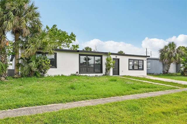 7930 Jeffery Ave, North Port, FL 34287 - mid-century home featuring stucco siding and a front lawn