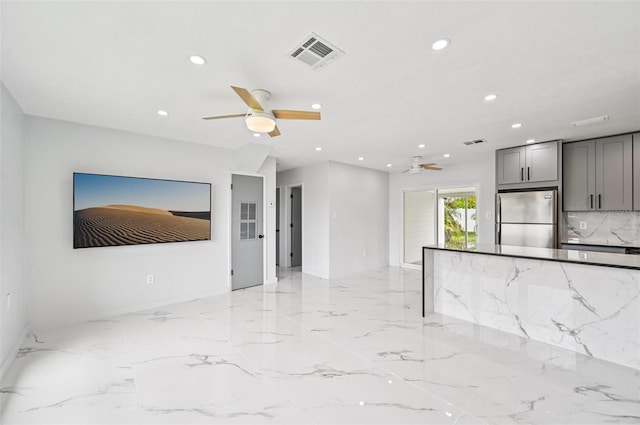 7930 Jeffery Ave, North Port, FL 34287 - unfurnished living room with a ceiling fan, recessed lighting, light marble finish flooring, and baseboards