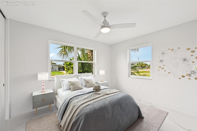 7930 Jeffery Ave, North Port, FL 34287 - bedroom featuring multiple windows, marble look tile flooring, and ceiling fan
