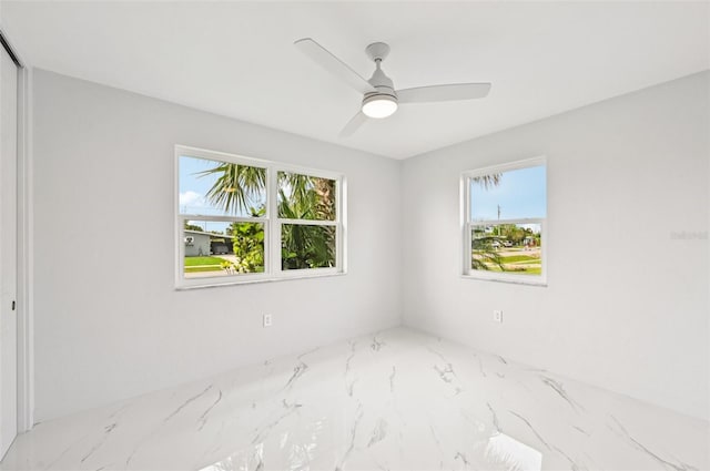 7930 Jeffery Ave, North Port, FL 34287 - spare room with plenty of natural light, marble tiled floors, and a ceiling fan