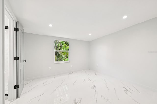 7930 Jeffery Ave, North Port, FL 34287 - unfurnished room with marble finish floors, recessed lighting, and baseboards