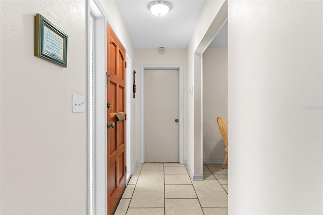 7276 21st St N, Saint Petersburg, FL 33702 - hallway featuring light tile patterned floors and baseboards