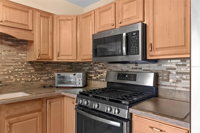 7276 21st St N, Saint Petersburg, FL 33702 - kitchen with appliances with stainless steel finishes, light brown cabinetry, tasteful backsplash, and light countertops