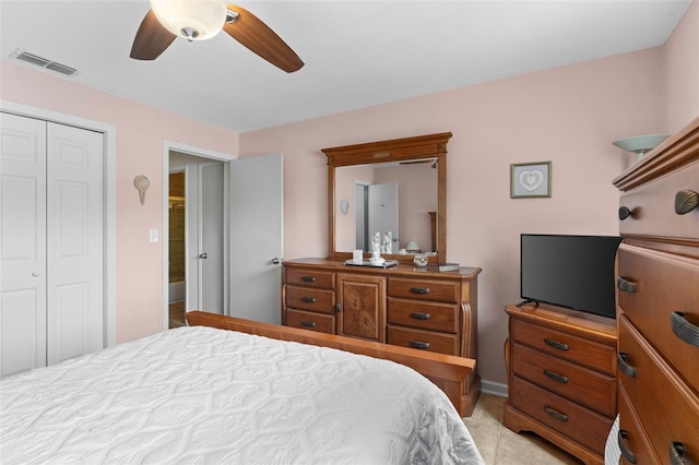 7276 21st St N, Saint Petersburg, FL 33702 - bedroom with a closet, a ceiling fan, light tile patterned floors, and baseboards