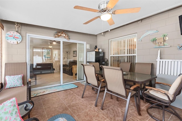 7276 21st St N, Saint Petersburg, FL 33702 - dining space featuring a ceiling fan, concrete block wall, and tile patterned flooring