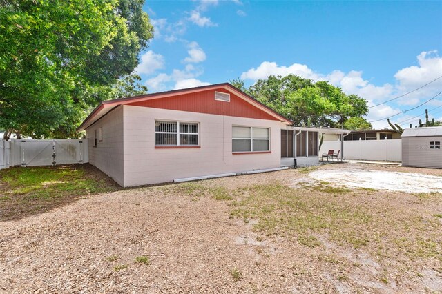 7276 21st St N, Saint Petersburg, FL 33702 - rear view of house with a gate and a sunroom