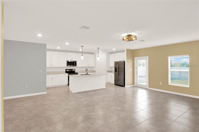 271 Inman Blvd, Winter Haven, FL 33881 - kitchen featuring stainless steel appliances, a sink, open floor plan, an island with sink, and white cabinets