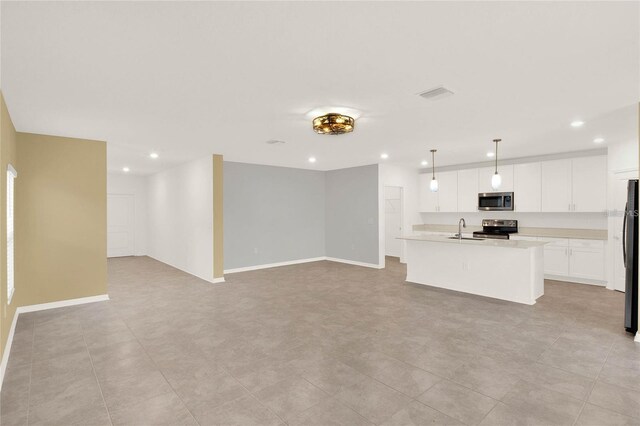 271 Inman Blvd, Winter Haven, FL 33881 - unfurnished living room featuring a sink, recessed lighting, and baseboards