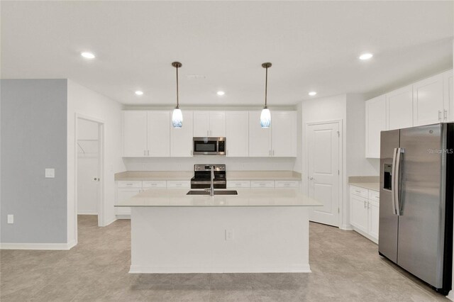 271 Inman Blvd, Winter Haven, FL 33881 - kitchen with appliances with stainless steel finishes, a sink, light countertops, an island with sink, and white cabinets