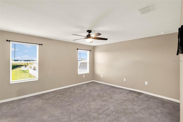 271 Inman Blvd, Winter Haven, FL 33881 - unfurnished room featuring a ceiling fan, dark carpet, and baseboards