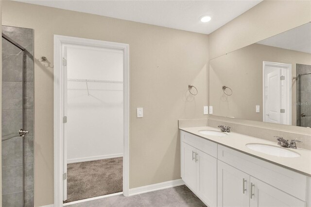 271 Inman Blvd, Winter Haven, FL 33881 - full bath with a spacious closet, a shower stall, double vanity, and baseboards