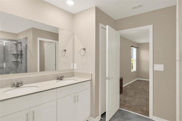 271 Inman Blvd, Winter Haven, FL 33881 - full bath featuring baseboards, double vanity, a stall shower, and tile patterned floors