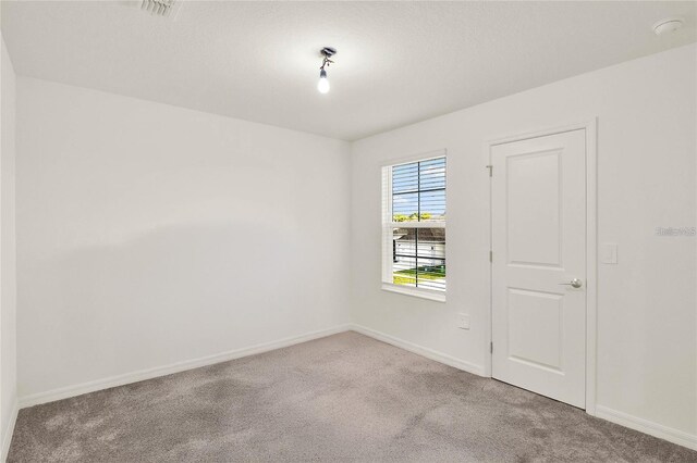 271 Inman Blvd, Winter Haven, FL 33881 - unfurnished room featuring carpet, baseboards, and a smoke detector