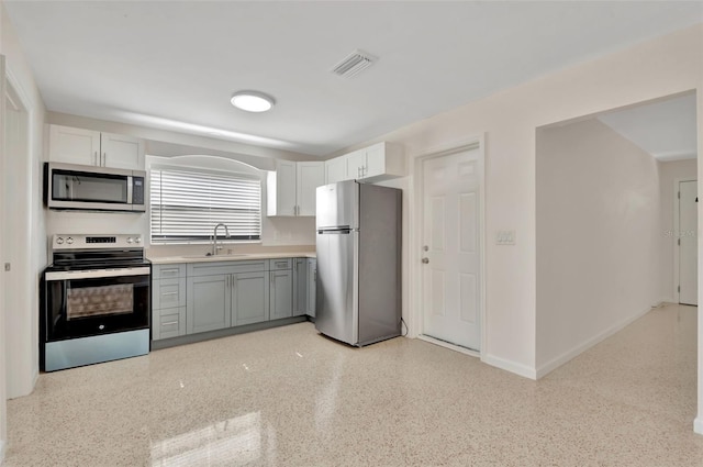 4714 W Vasconia St, Tampa, FL 33629 - kitchen featuring appliances with stainless steel finishes, light countertops, white cabinets, and gray cabinets