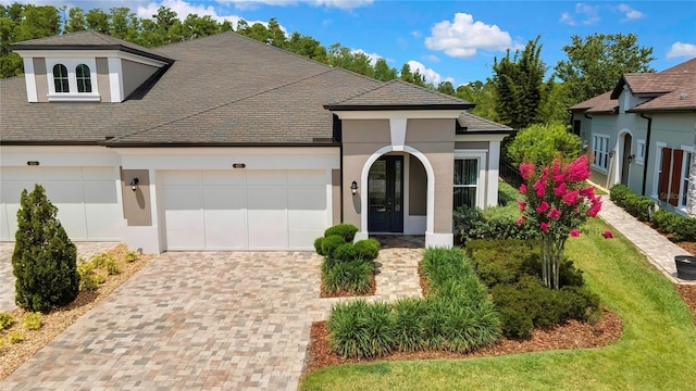 4155 Barletta Ct, Wesley Chapel, FL 33543 - view of front of home with stucco siding, a garage, decorative driveway, and a front lawn