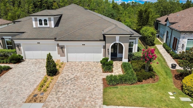 4155 Barletta Ct, Wesley Chapel, FL 33543 - view of front of house featuring stucco siding, a garage, and decorative driveway