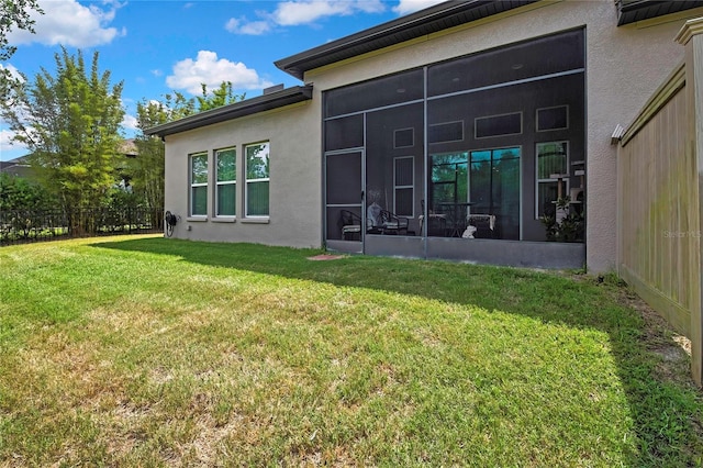 4155 Barletta Ct, Wesley Chapel, FL 33543 - rear view of house featuring stucco siding and a sunroom