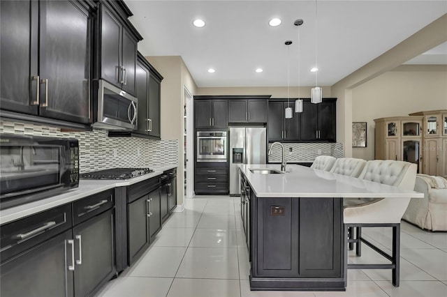 4155 Barletta Ct, Wesley Chapel, FL 33543 - kitchen with stainless steel appliances, a sink, open floor plan, backsplash, and recessed lighting