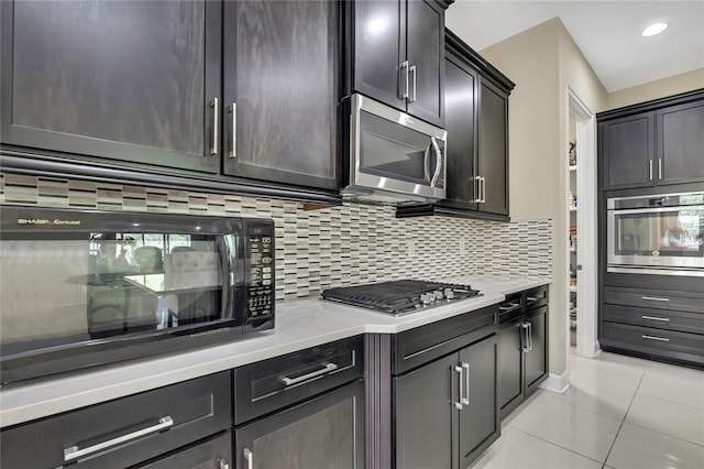 4155 Barletta Ct, Wesley Chapel, FL 33543 - kitchen with stainless steel appliances, light tile patterned floors, light countertops, tasteful backsplash, and recessed lighting