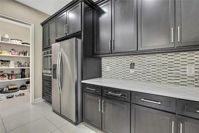 4155 Barletta Ct, Wesley Chapel, FL 33543 - kitchen with appliances with stainless steel finishes, backsplash, light tile patterned floors, and open shelves
