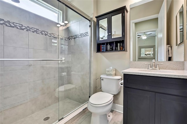 4155 Barletta Ct, Wesley Chapel, FL 33543 - bathroom with toilet, a shower stall, vanity, ceiling fan, and baseboards