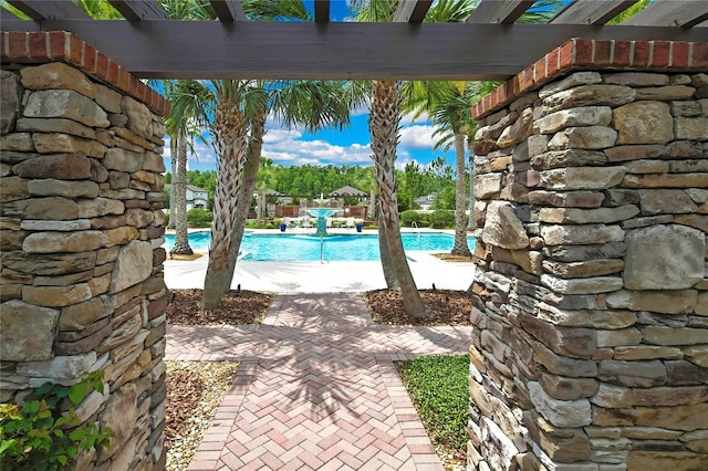 4155 Barletta Ct, Wesley Chapel, FL 33543 - view of patio featuring a community pool and a pergola