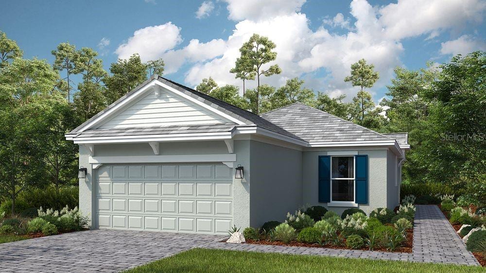 29472 Velletri Ln, Wesley Chapel, FL 33543 - ranch-style house with stucco siding, a garage, and decorative driveway