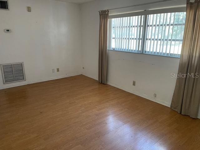 15034 Lake Magdalene Blvd, Tampa, FL 33618 - spare room featuring wood finished floors, plenty of natural light, and baseboards