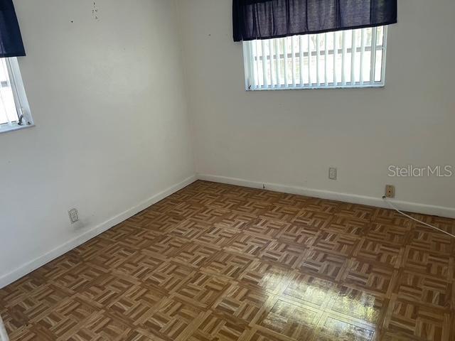 15034 Lake Magdalene Blvd, Tampa, FL 33618 - empty room with healthy amount of natural light and baseboards