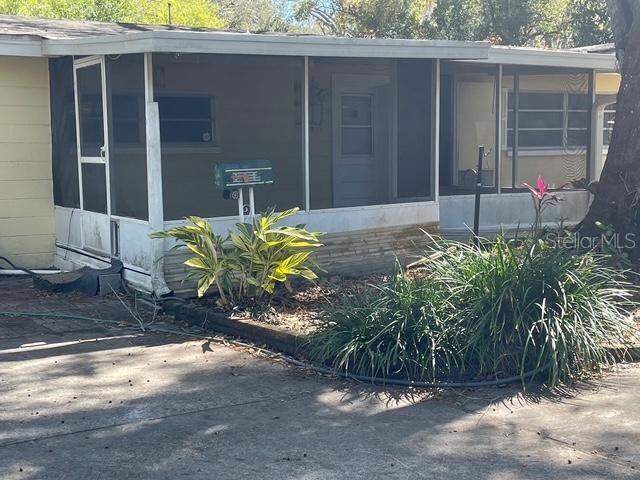 15034 Lake Magdalene Blvd, Tampa, FL 33618 - view of side of property with a sunroom