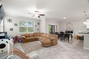 1395 White Fox Run, Lutz, FL 33549 - living room featuring a ceiling fan, crown molding, and light tile patterned flooring
