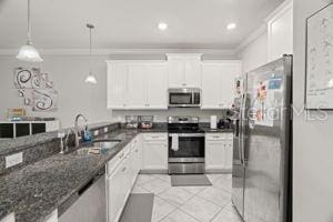 1395 White Fox Run, Lutz, FL 33549 - kitchen with appliances with stainless steel finishes, crown molding, a sink, white cabinetry, and light tile patterned floors