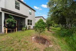 1395 White Fox Run, Lutz, FL 33549 - back of house featuring stucco siding and a lawn