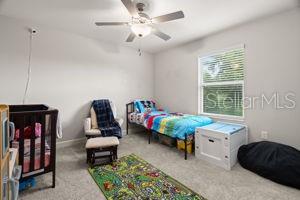 1395 White Fox Run, Lutz, FL 33549 - bedroom featuring carpet and a ceiling fan