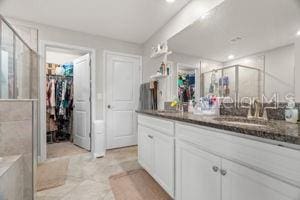 1395 White Fox Run, Lutz, FL 33549 - bathroom featuring a stall shower, a walk in closet, vanity, and recessed lighting