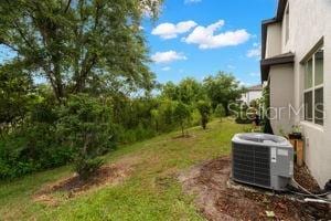 1395 White Fox Run, Lutz, FL 33549 - view of green lawn with central air condition unit