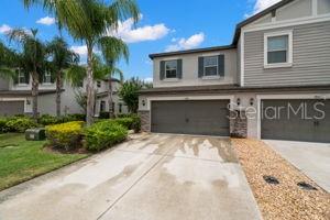 1395 White Fox Run, Lutz, FL 33549 - townhome / multi-family property with an attached garage and concrete driveway
