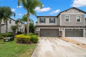 1395 White Fox Run, Lutz, FL 33549 - view of front of home featuring a garage, driveway, and a front lawn