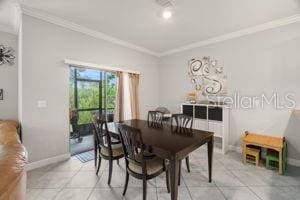 1395 White Fox Run, Lutz, FL 33549 - dining space with ornamental molding, baseboards, and light tile patterned floors