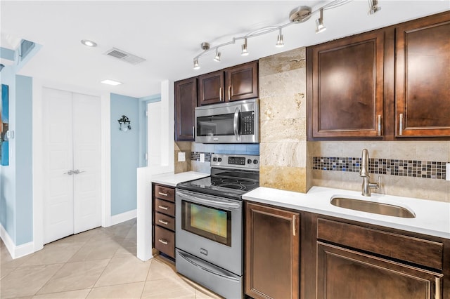 4900 Brittany Dr S Unit 611, Saint Petersburg, FL 33715 - kitchen featuring stainless steel appliances, light countertops, and backsplash