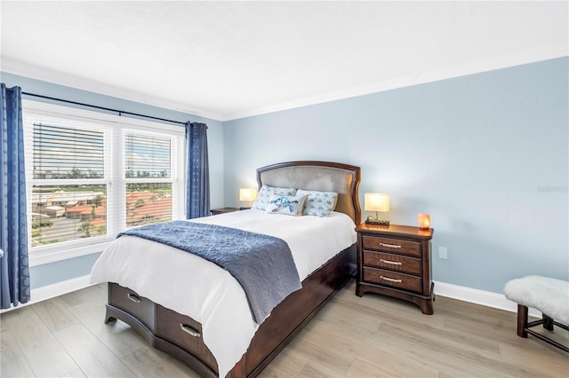 4900 Brittany Dr S Unit 611, Saint Petersburg, FL 33715 - bedroom with light wood finished floors and crown molding