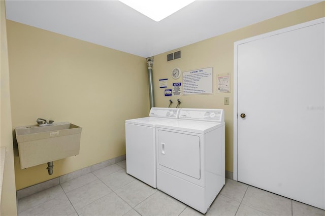 4900 Brittany Dr S Unit 611, Saint Petersburg, FL 33715 - communal laundry room featuring washing machine and dryer and light tile patterned floors