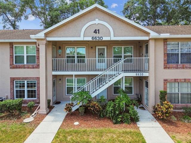 6630 Spring Flower Dr Unit 14, New Port Richey, FL 34653 - view of building exterior with stairway