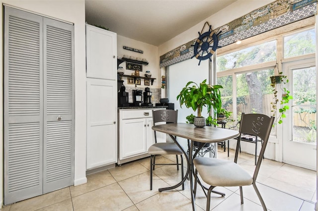 6630 Spring Flower Dr Unit 14, New Port Richey, FL 34653 - dining area with light tile patterned flooring, plenty of natural light, and bar
