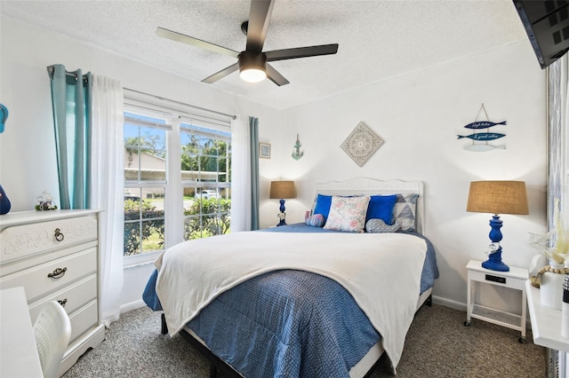 6630 Spring Flower Dr Unit 14, New Port Richey, FL 34653 - bedroom with carpet, a textured ceiling, baseboards, and a ceiling fan