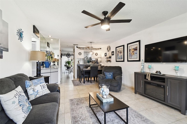 6630 Spring Flower Dr Unit 14, New Port Richey, FL 34653 - living room with ceiling fan, a textured ceiling, and light tile patterned flooring